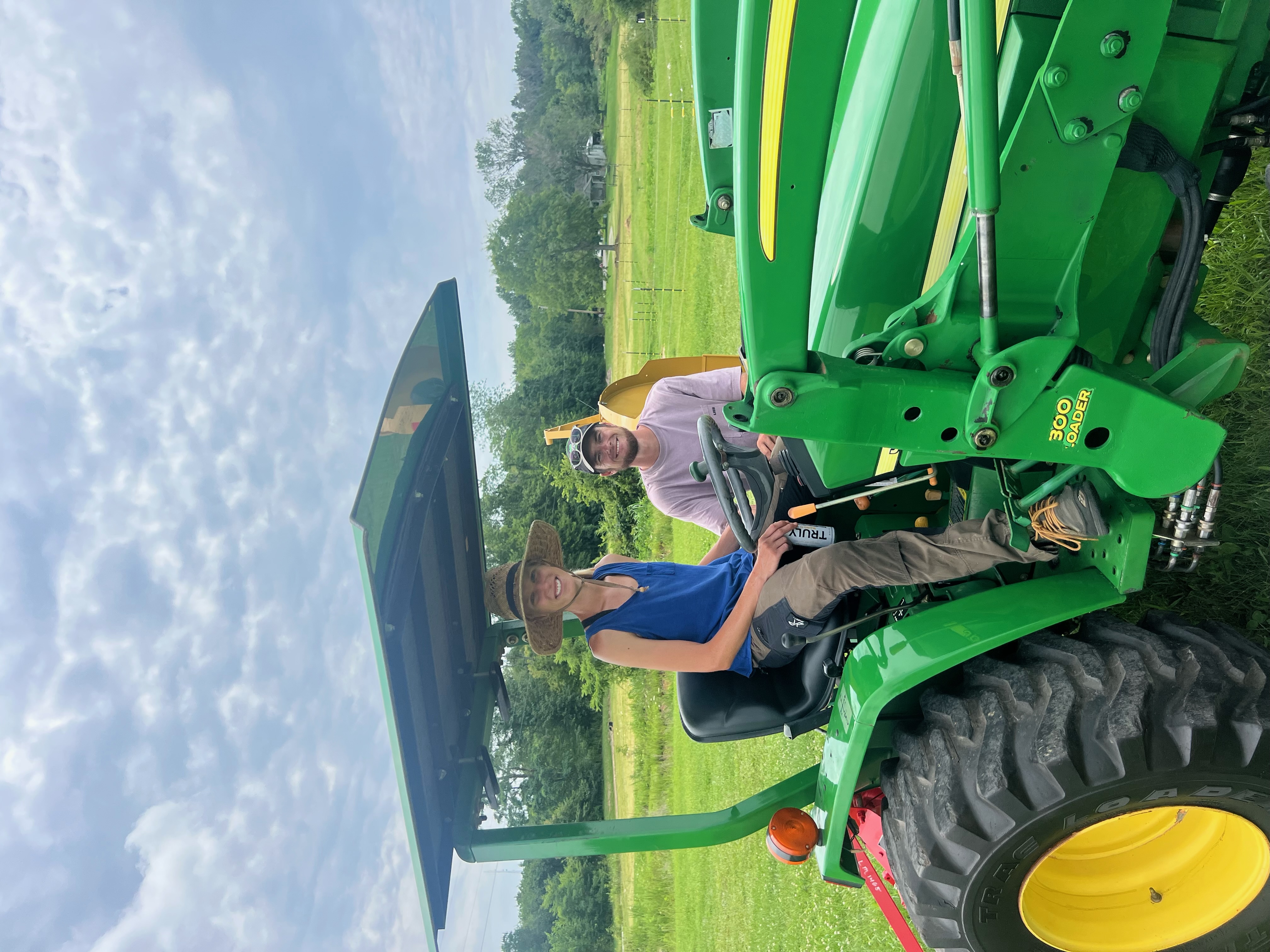 Colton van Assche and Brittney Blackshear showing off their harvest at Blue Heron Farmstead